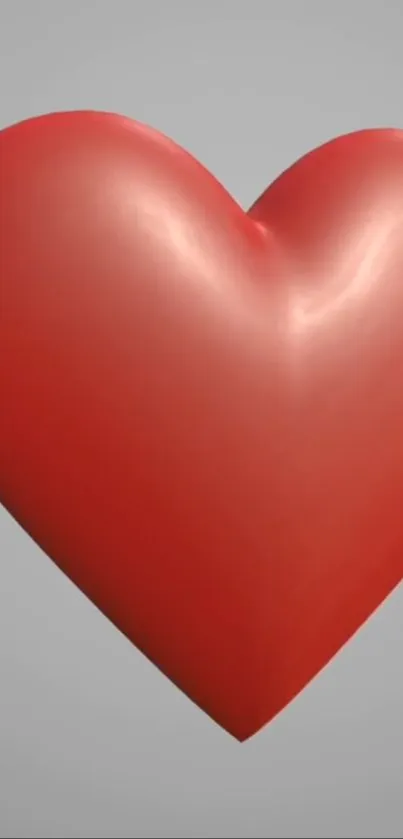 3D red heart with a smooth finish on a minimalist gray background.