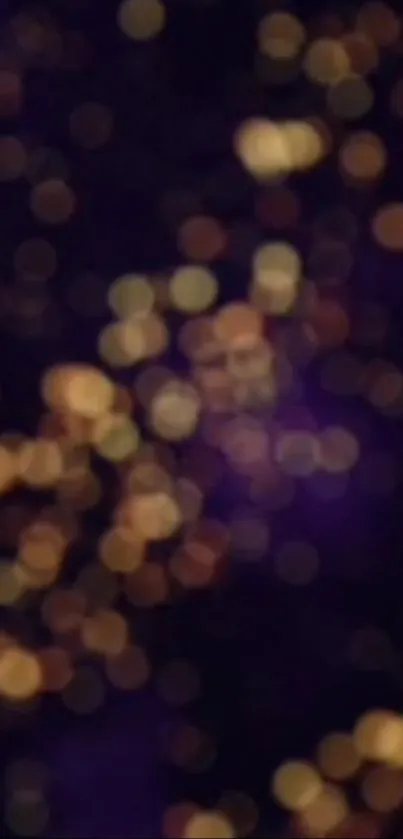 Abstract bokeh wallpaper with golden lights and dark purple background.