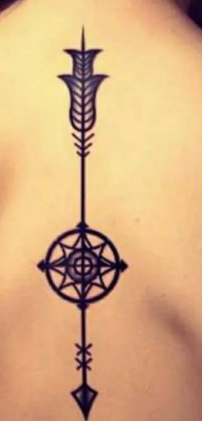 Minimalist compass arrow tattoo on back