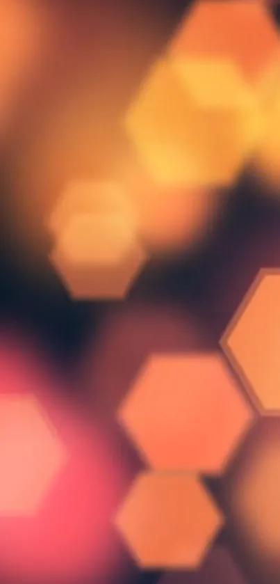 Abstract glowing hexagon shapes in warm orange tones on mobile wallpaper.