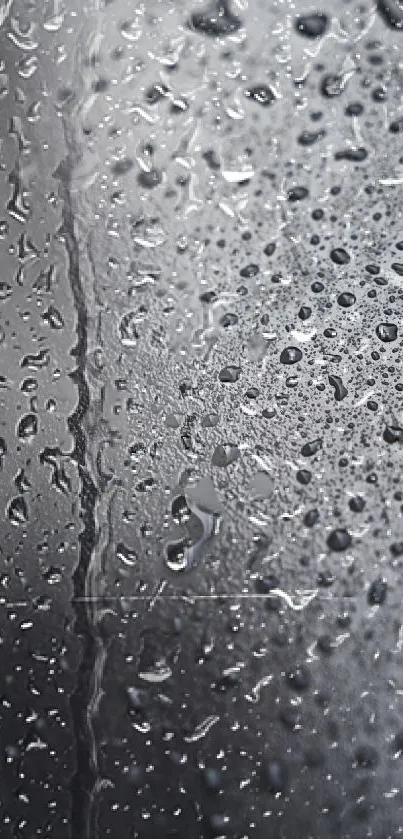 Close-up of glass with raindrops and gray tones.