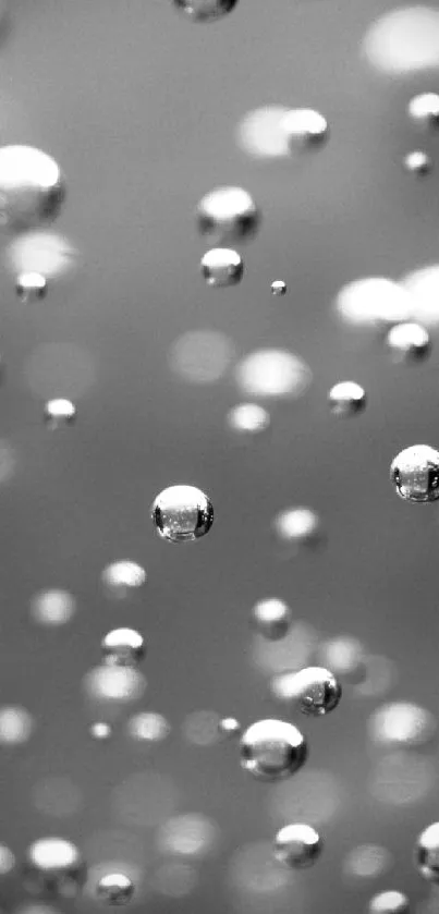 Floating silver droplets on abstract gray background.