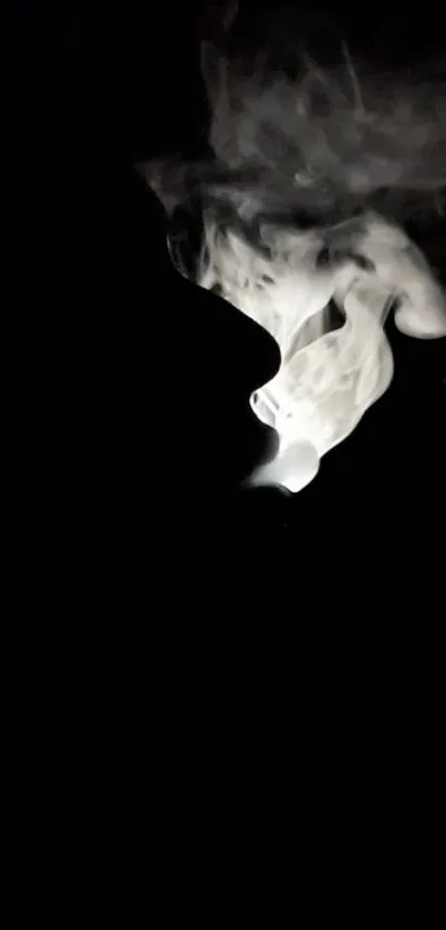 Silhouette with mysterious white smoke against a dark background wallpaper.