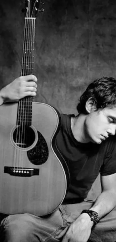 Black and white wallpaper with man and acoustic guitar in reflective pose.