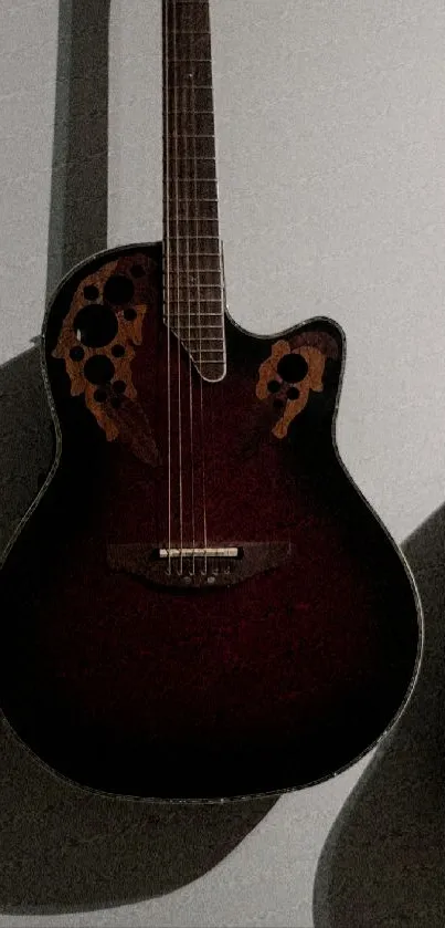 Elegant acoustic guitar with dark wood finish and intricate sound holes.