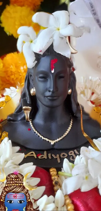 Adiyogi statue adorned with white flowers and vibrant colors.