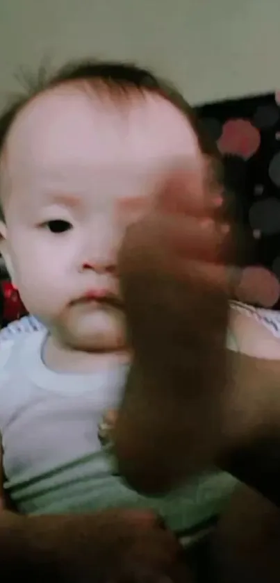 Adorable baby smiling with soft focus and warm tones.