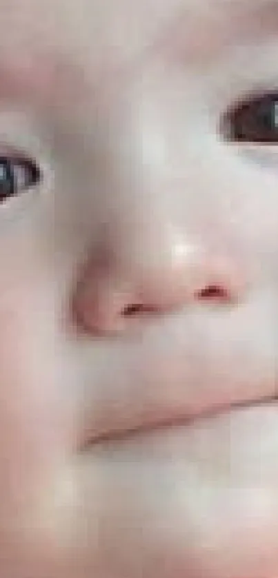 Close-up of a baby with gentle features and expressive eyes.