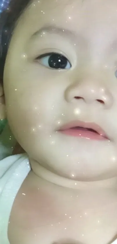 Adorable baby face with a charming sparkle effect.