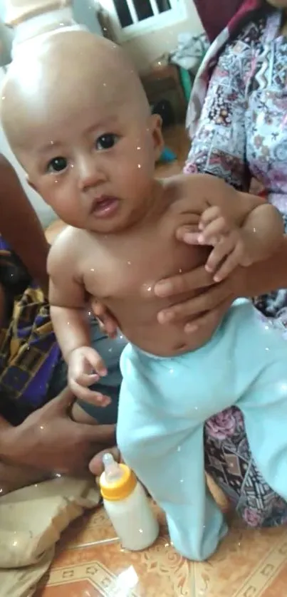 Adorable baby in blue pants with a charming smile.