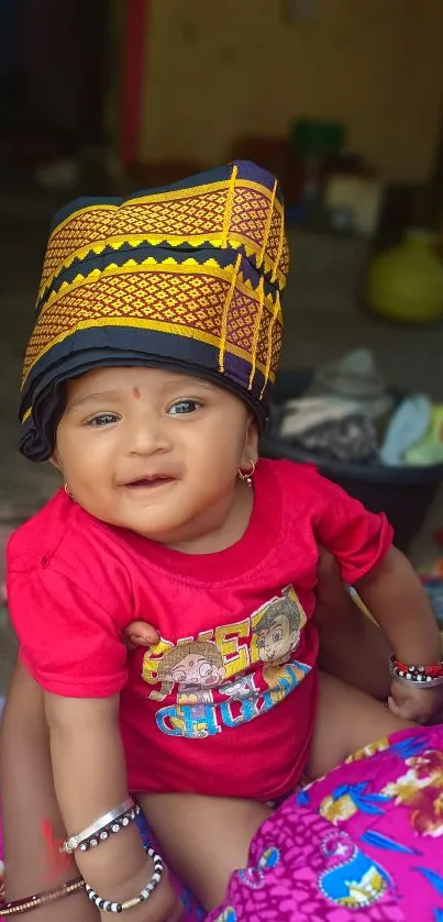 Cute baby in a vibrant outfit, smiling happily.