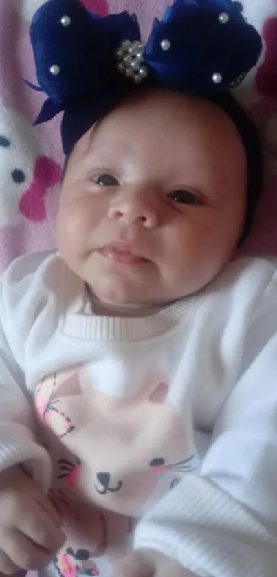 Cute baby wearing a blue headband with a sweet outfit.