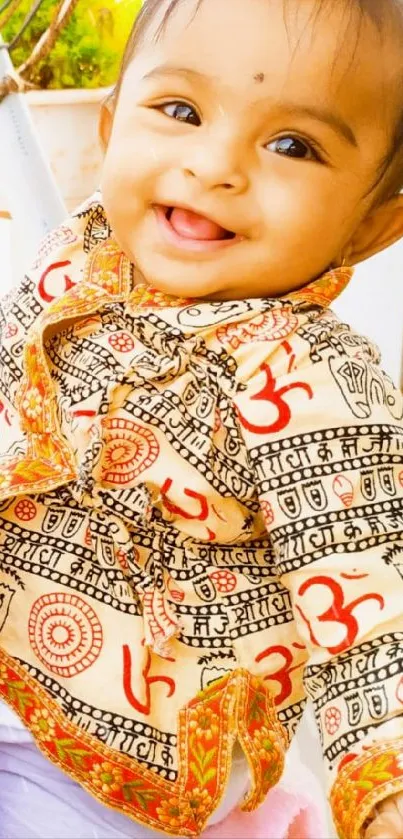 Smiling baby in colorful traditional outfit.