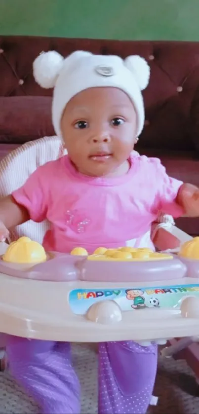 Adorable baby in a walker with a pink shirt and cozy room background.