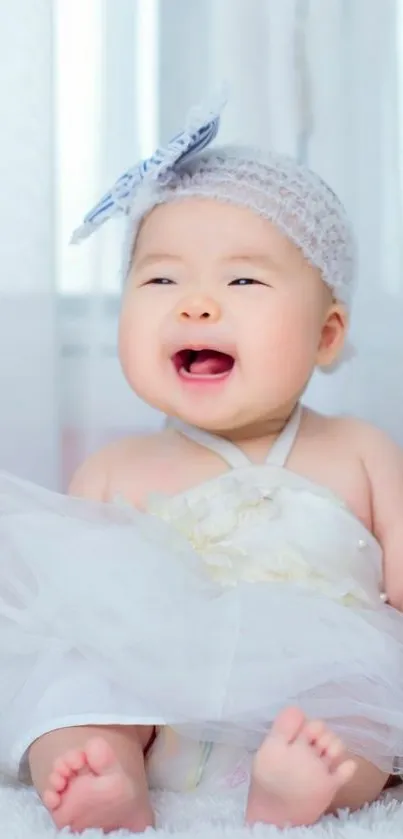 Adorable baby wearing white tutu, smiling joyfully.