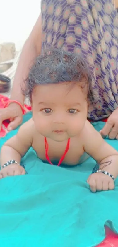 Adorable baby on a vibrant blue blanket.