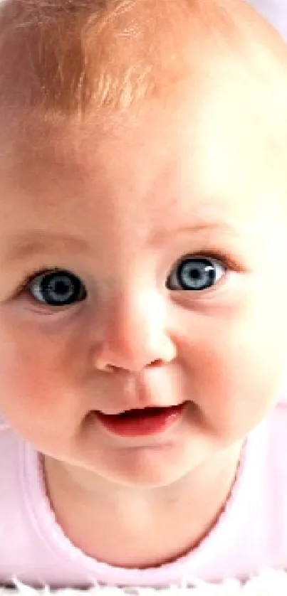 Adorable baby with blue eyes on a soft white blanket.