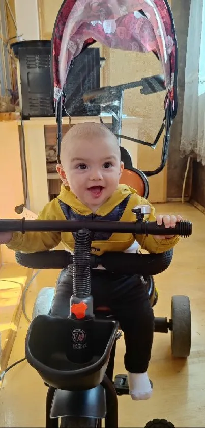 Happy baby riding a tricycle indoors.