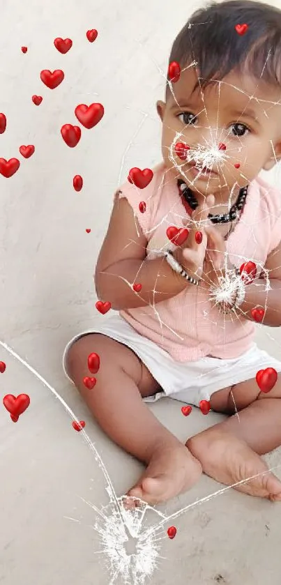 Adorable baby in peach attire sitting on beige surface.