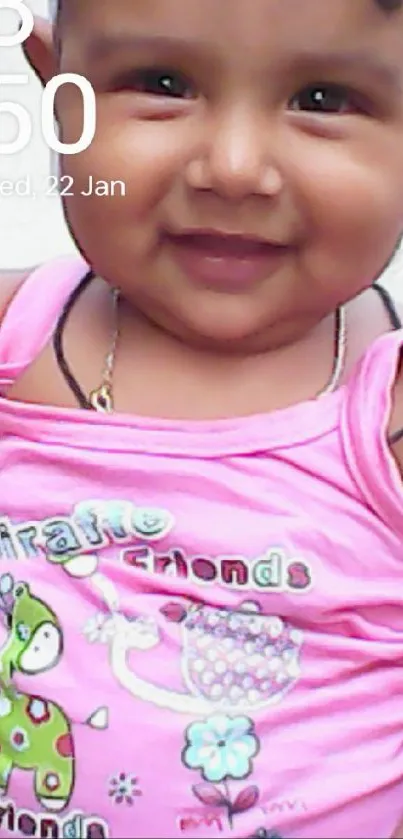 Smiling baby in pink outfit as wallpaper