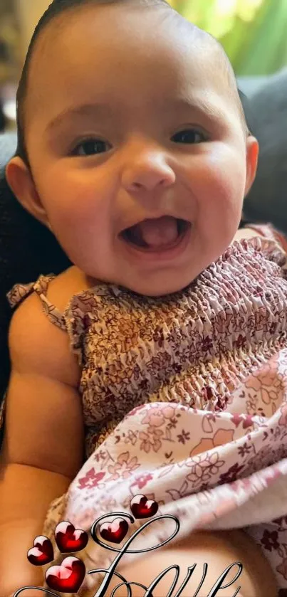 Adorable baby smiling with 'Love' and hearts.