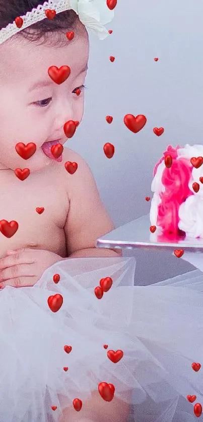 Adorable baby with balloons and cake, wearing a white tulle skirt.