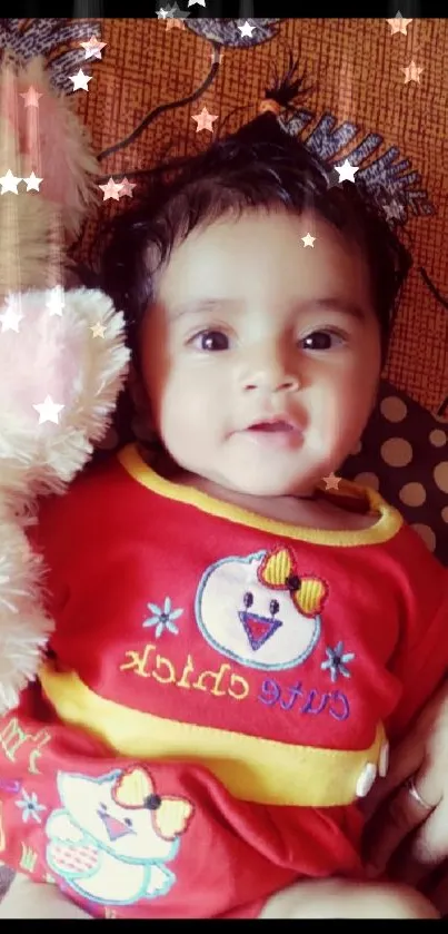 Adorable baby with teddy bear on a brown background.