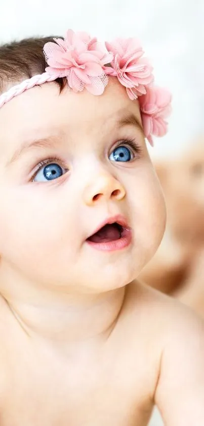 Adorable baby with pink headband and teddy bears on white background.