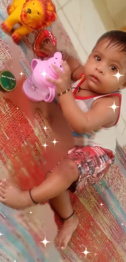 Cute baby playing with toys on a colorful mat.