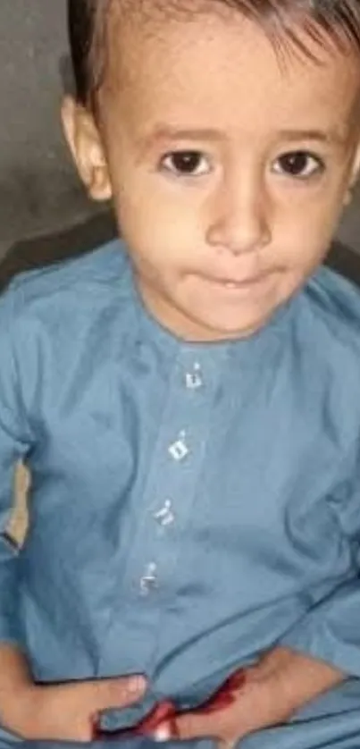 Charming child in blue attire with a cute smile.