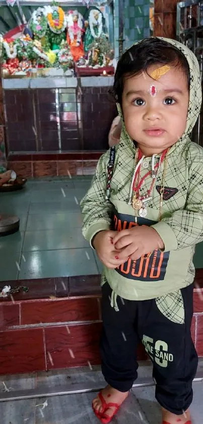 Adorable child stands in colorful temple.