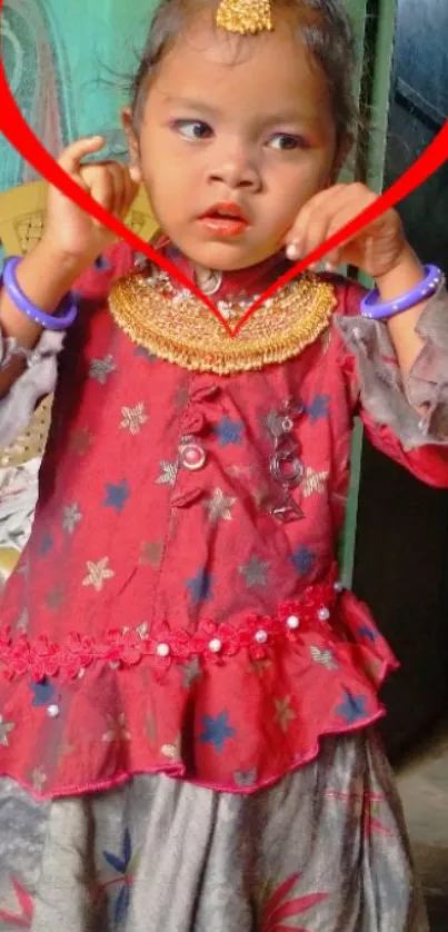 Child in traditional dress with red heart.