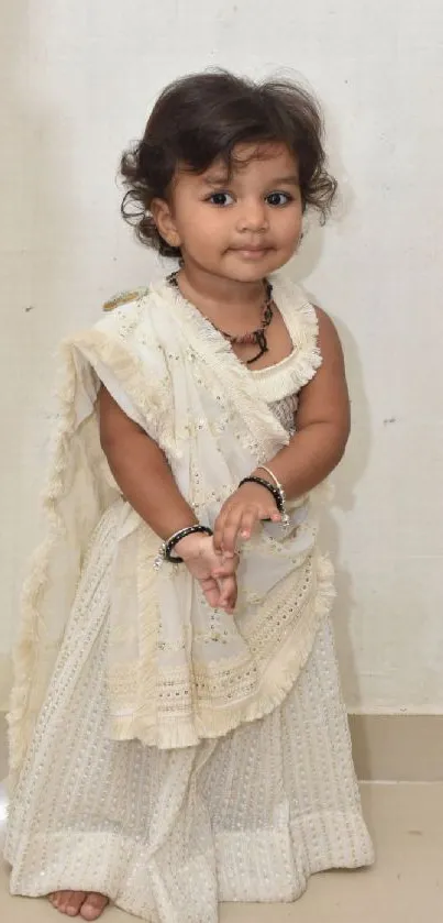 Adorable child wearing traditional attire with an innocent smile.