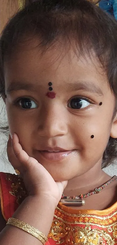 Adorable young child in traditional dress with a joyful expression.