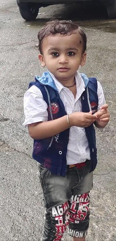 Cute child outdoors with urban backdrop.