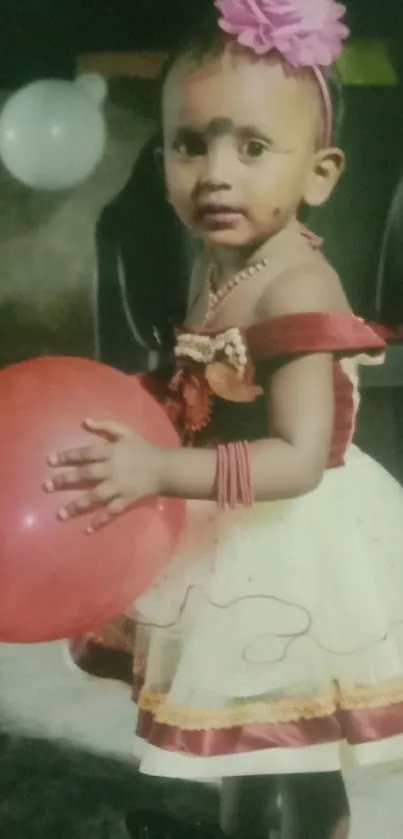 Little girl with red balloon in festive attire