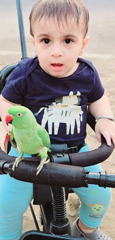 A cute child with a green parrot on a tricycle outdoors.