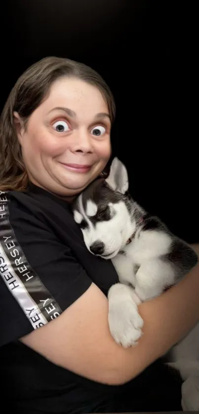 A joyful person with a husky cuddling, set against a dark background.