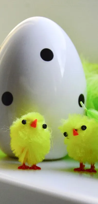 Fluffy yellow chicks with a dotted egg and green feathers in Easter-themed mobile wallpaper.