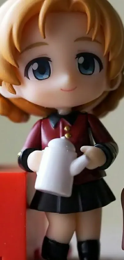 Cute anime figurine with blue eyes and blonde hair holding a cup.