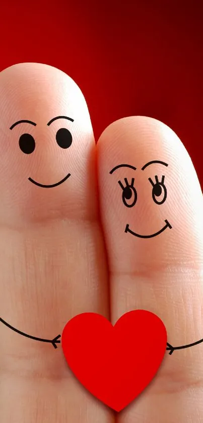 Fingers with doodle faces hold a red heart on a vivid red background.