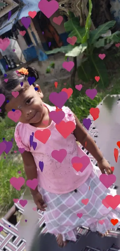 Adorable young girl with heart effects in garden setting.