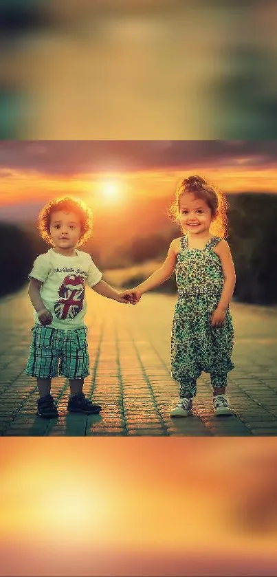 Two smiling children holding hands at sunset.