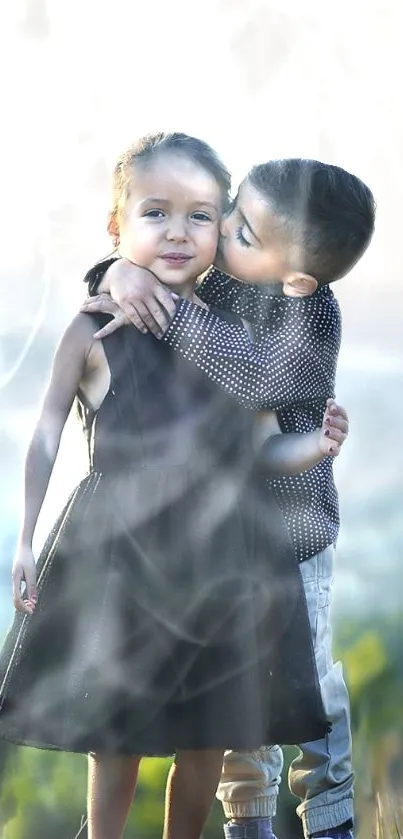 Two young children sharing a warm hug in a picturesque outdoor setting.