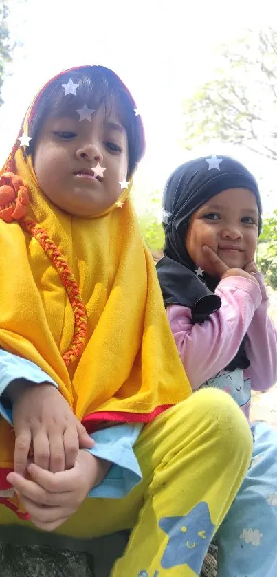 Adorable children smiling outdoors under sunlight.