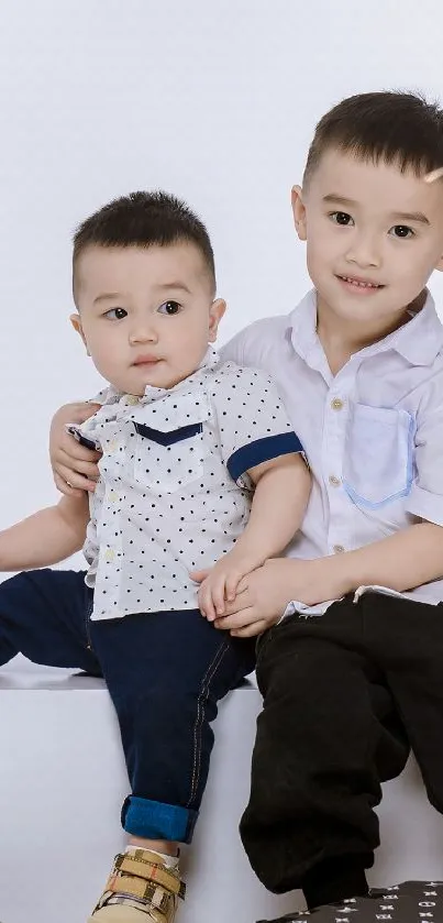 Two adorable kids with stylish gift boxes.