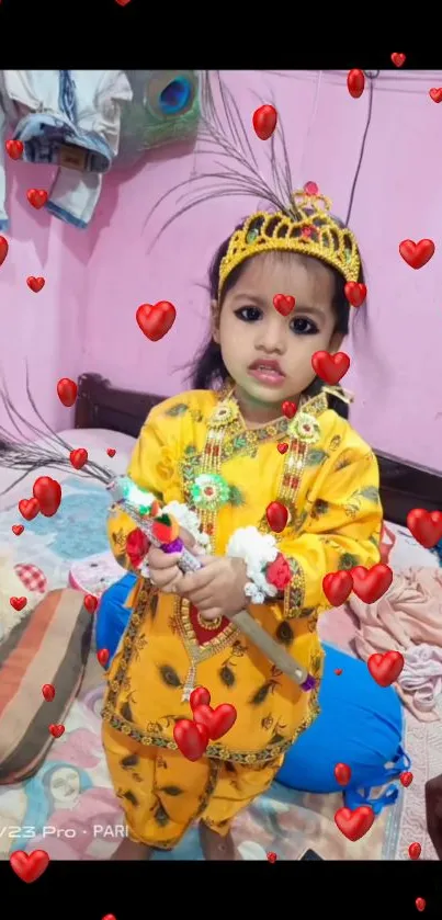 Cute child dressed as Krishna with hearts background.