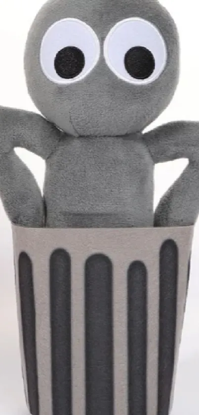 Grey plush toy with big eyes in a trash can.