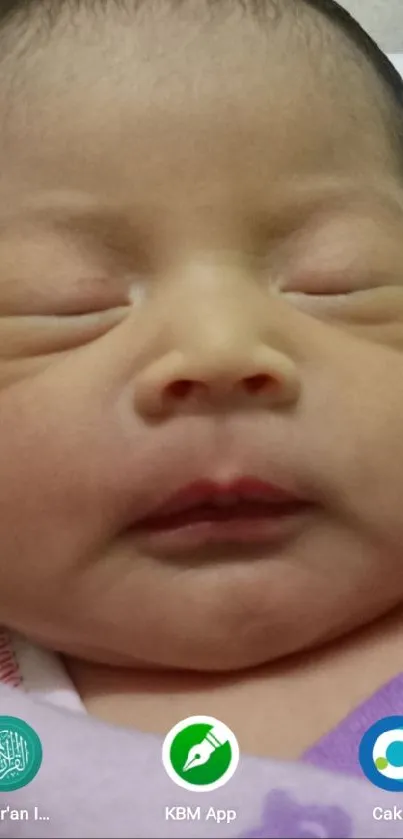 Adorable sleeping baby with a peaceful expression on mobile screen.