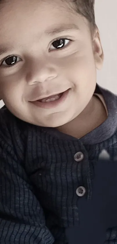 Adorable smiling child in navy sweater, close-up portrait.